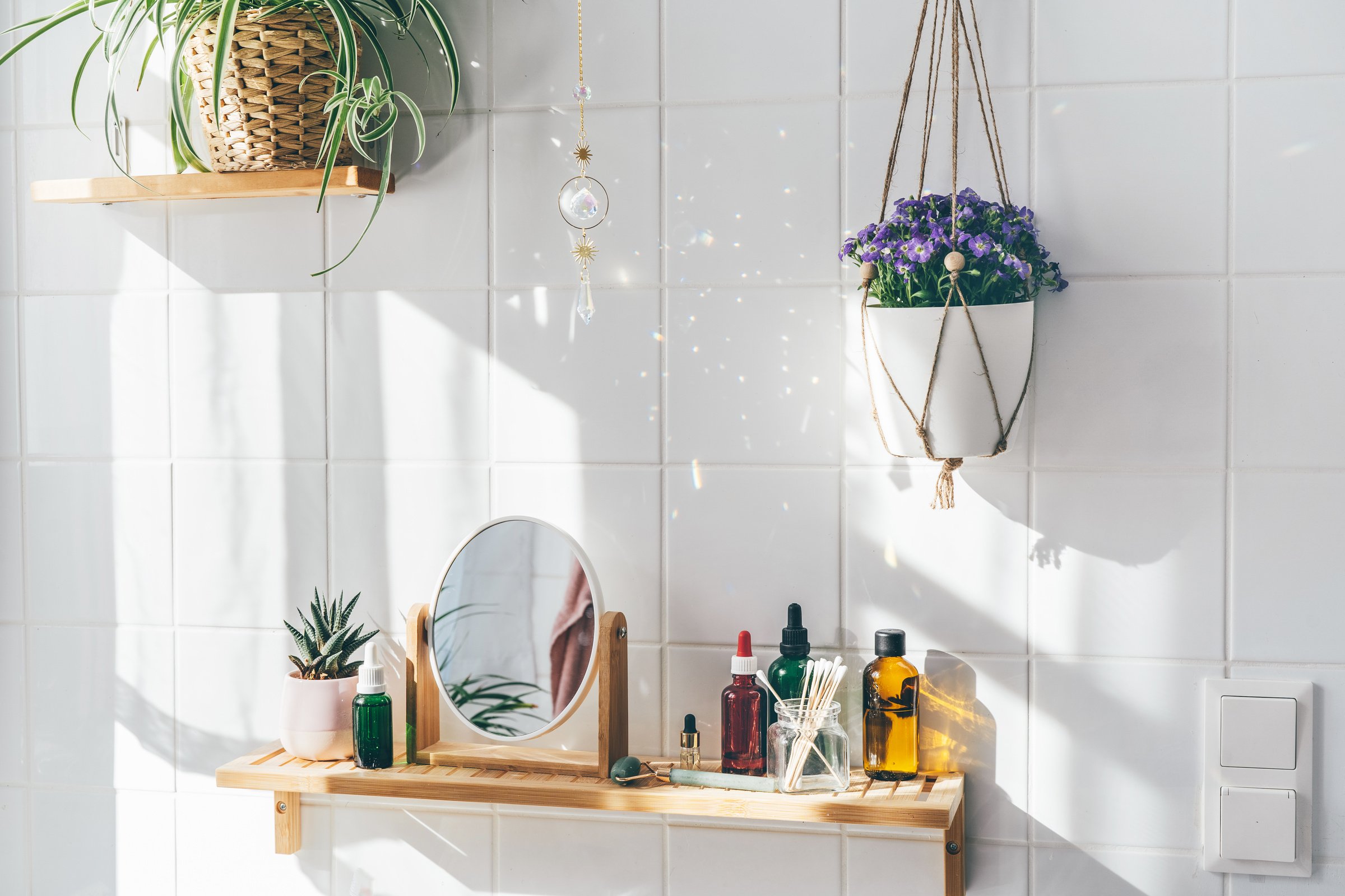 Hanging Crystal Sun Catcher against White Tile Wall